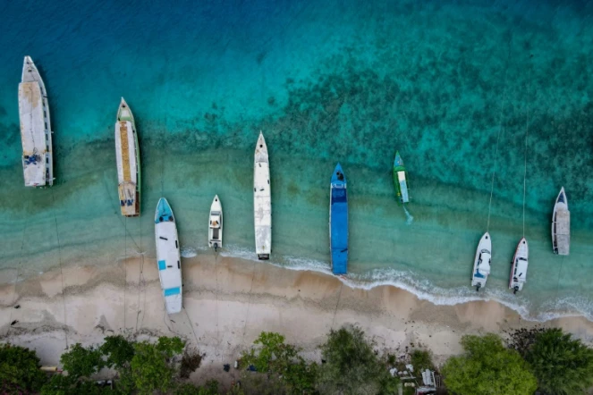 Des bateaux à l'ancre le long d'une plage désertée par les touristes, sur l'île indonésienne de Gili  Trawangan le 22 novembre 2021