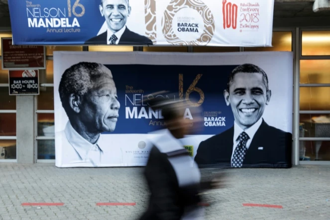 Les portraits de Nelson Mandela et de Barack Obama sur une affiche à l'entrée du stade Wanderers, le 17 juillet 2018 à Johannesburg, où l'ancien président américain prononcera un discours, point d'orgue des célébrations du centième anniversaire de la naissance du premier chef d'Etat noir sud-africain