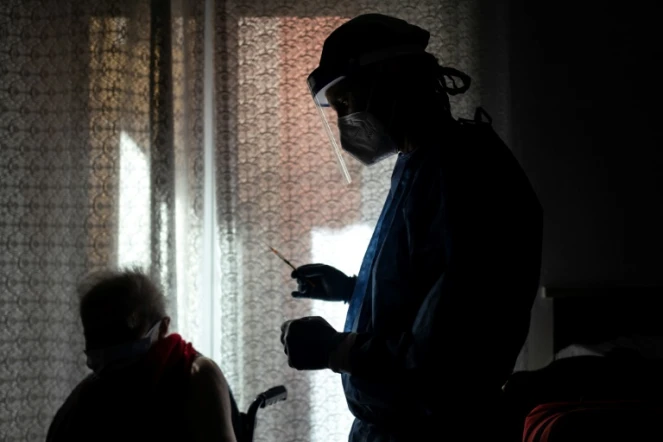 Une femme de 80 ans (g) reçoit une dose de vaccin Moderna contre le Covid-19 à Dronero, dans le nord-ouest de l'Italie, le 13 mars 2021
