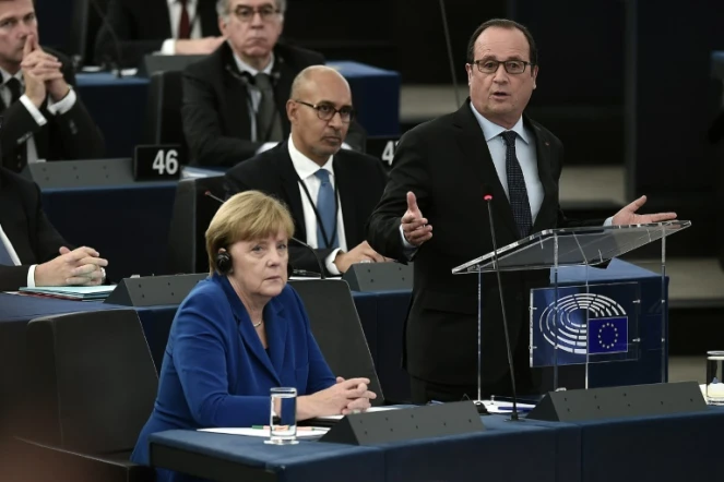 Le président français Francois Hollande (D) prononce un discours à côté de la chancelière allemande (G) au parlement européen, le 7 octobre 2015 à Strasbourg (France)