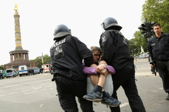 Un protestataire de la manifestation "anticorona" est interpellé par des policiers dans le centre de Berlin, le 30 août