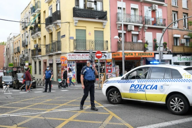 Des policiers bloquent une rue de Madrid, le 20 septembre 2020, pendant une manifestation contre les nouvelles restrictions destinées à enrayer la progression du nouveau coronavirus 