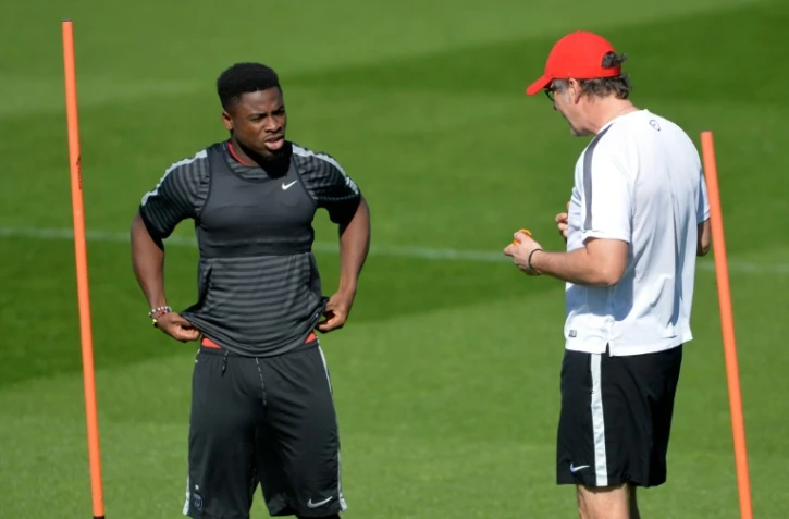 Le défenseur parisien Serge Aurier échange avec son entraîneur Laurent Blanc, au centre d'entraînement du club au Camp des Loges, le 14 avril 2015