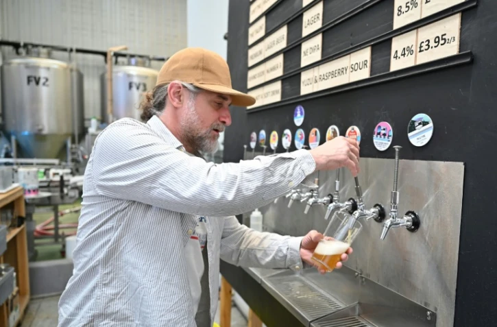 Un employé tire une pinte de bière à la brasserie Pressure Drop, au nord de Londres, le 21 mai 2022.
Les salariés de Pressure Drop prennent part à un test géant du travail en semaine de quatre jours, pendant six mois., impliquant 3.000 employés dans soixante entreprises au Royaume-Uni
