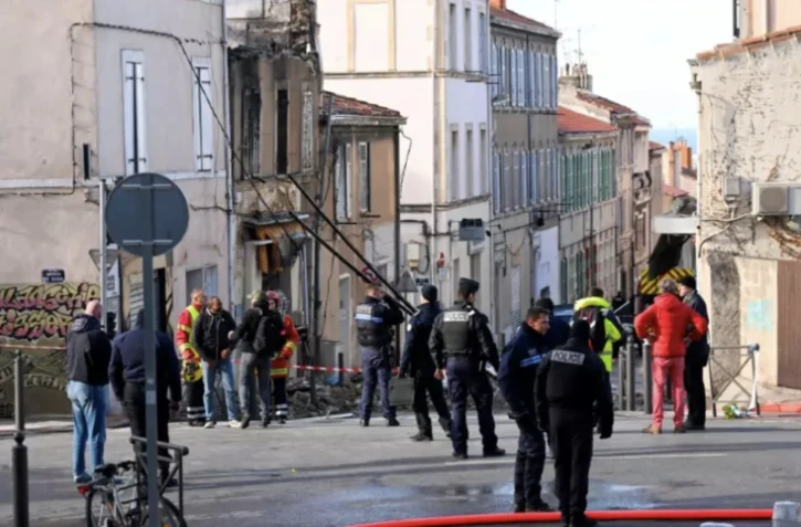 Des pompiers et policiers près d'un bâtiment partiellement détruit par un incendie qui s'est déclaré dans la nuit, le 3 décembre 2023 à Marseille, dans les Bouches-du-Rhône ( AFP / NICOLAS TUCAT )
