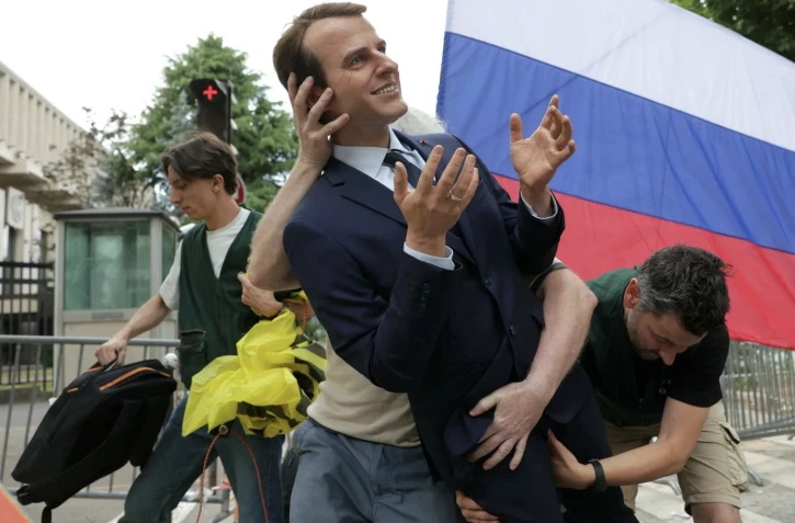 Mardi soir, Greenpeace a déposé la statue de cire de Macron devant le siège EDF à Paris pour protester contre les liens entre la France et la Russie.  - Thomas SAMSON / AFP