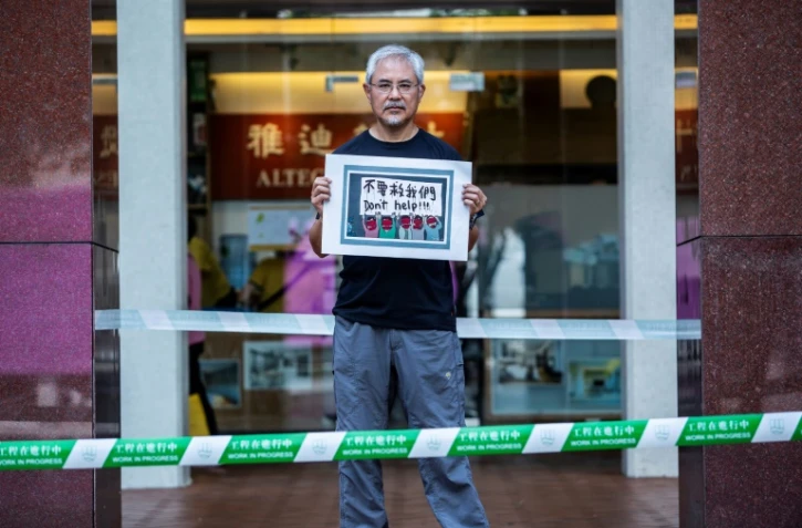 Le caricaturiste Wong Kei-kwan pose avec un dessin à Hong Kong le 20 juin 2020