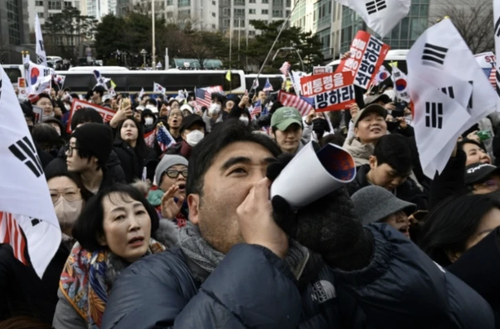 Des soutiens de Yoon Suk Yeol se rassemblent devant un tribunal de Séoul où le président sud-coréen suspendu comparaît lors d'une audience sur la demande de prolongation de sa détention, le 18 janvier 2025 ( AFP / ANTHONY WALLACE )