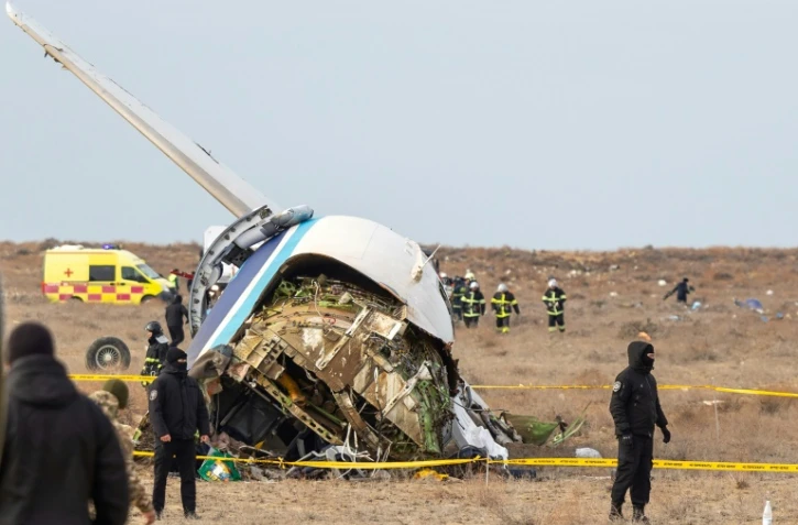 Des spécialistes des situations d'urgence travaillent sur le site du crash d'un avion de ligne de la compagnie Azerbaijan Airlines près de la ville d'Aktaou, dans l'ouest du Kazakhstan, le 25 décembre 2024