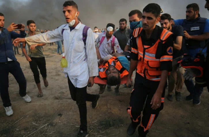 Un blessé palestinien est transporté le 5 octobre  2018 après des affrontements avec des forces armées israéliennes dans la bande de Gaza