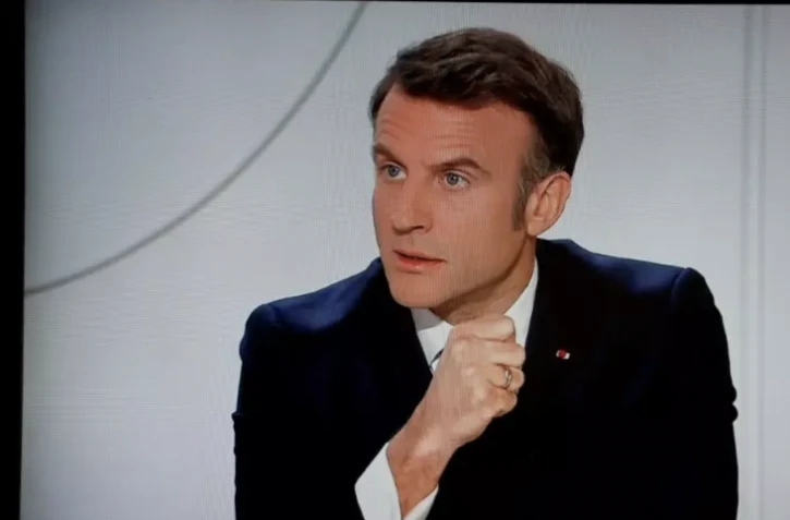 Le président Emmanuel Macron lors d'un entretien sur TF1 et France 2 retransmis à la télévision, le 14 mars 2024 à Paris ( AFP / Ludovic MARIN )