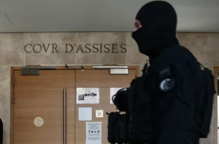 Un membre de l'équipe régionale d'intervention et de sécurité (ERIS) devant l'entrée de la cour d'assises du tribunal d'Aix-en-Provence, où se déroule le procès des membres présumés de la DZ Mafia, le 23 mars 2026 dans les Bouches-du-Rhône ( AFP / Thibaud MORITZ )