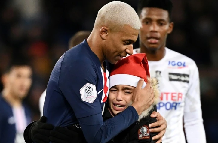 C'était jour de fête au Parc des Princes et pour ce jeune supporter déguisé en Père Noël dans les bras de Kylian Mbappé, double buteur contre Amiens, le 21 décembre 2019