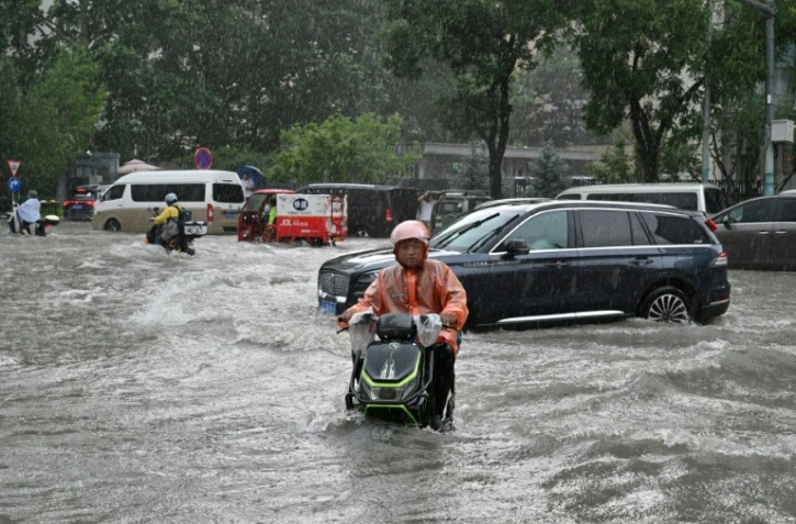 Torrential rain and flooding killed six people and forced at least 130,000 to evacuate in China's Guangxi region