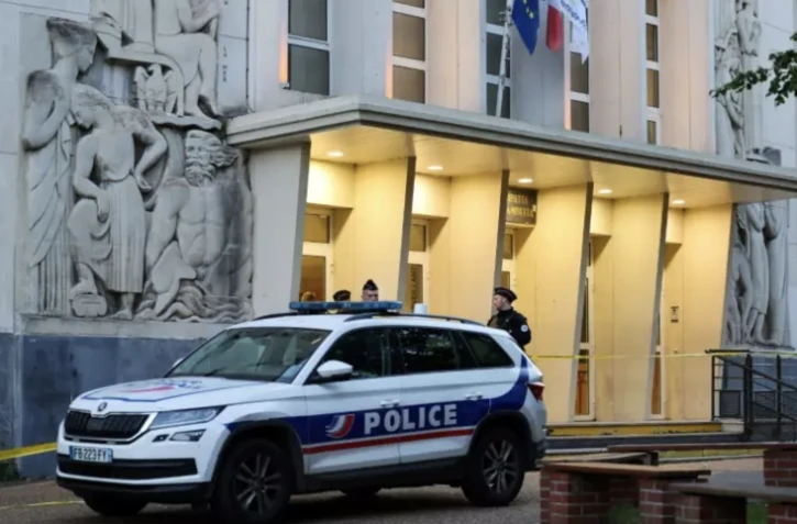 Des policiers montent la garde à l'entrée du lycée Gambetta à Arras, le 14 octobre 2023 ( AFP / Denis Charlet )