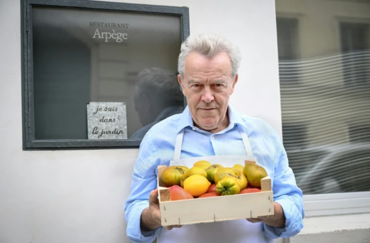 Le chef Alain Passard pose devant son restaurant l'Arpège à Paris où il sert désormais une cuisine exclusivement végétale, le 22 juillet 2025