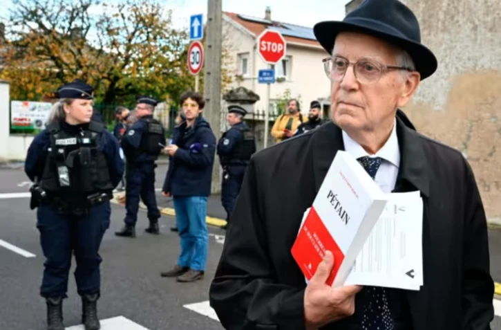 Le président de l'Association pour défendre la mémoire du maréchal Pétain (ADMP), Jacques Boncompain, devant l'église où a eu lieu une cérémonie en hommage à Pétain organisée par son association, le 15 novembre 2025, à Verdun dans la Meuse ( AFP / Jean-Christophe VERHAEGEN )