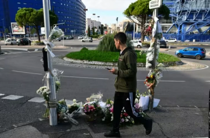Des fleurs sont déposées à l'endroit où Mehdi Kessaci a été tué à Marseille, le 18 novembre 2025 ( AFP / Christophe SIMON )