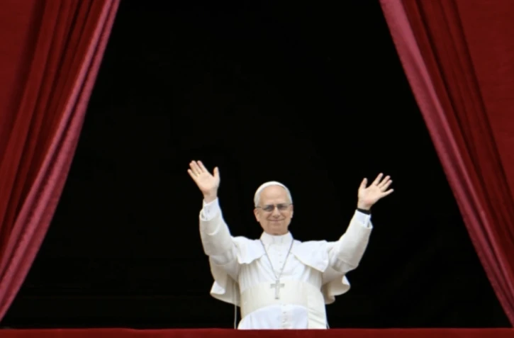 Le pape Léon XIV salue la foule de fidèles depuis le balcon de la basilique Saint-Pierre au Vatican après la prière Regina Caeli, le 11 mai 2025 ( AFP / Alberto PIZZOLI )