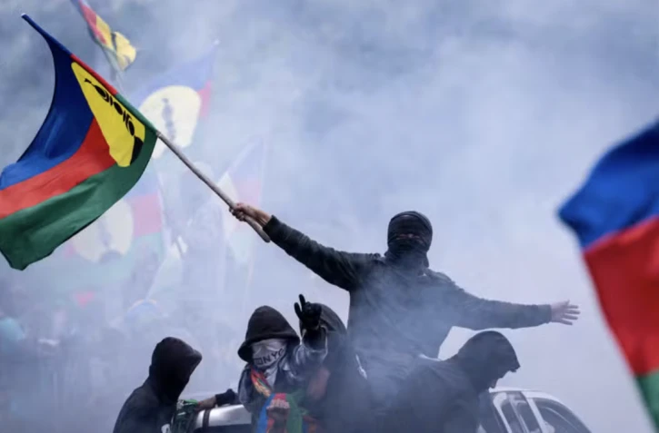 Des habitants agitent des drapeaux kanaks lors d’une procession vers Nouméa, en Nouvelle-Calédonie, le 28 septembre 2024. SEBASTIEN BOZON / AFP 