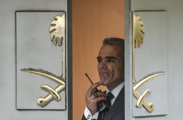 Un membre des services de sécurité regarde par la porte du consulat saoudien à Istanbul, le 15 octobre 2018