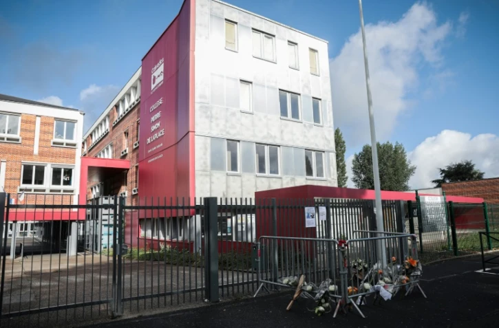 Des fleurs déposées devant le collège Pierre-Simon de Laplace dont le principal a été retrouvé mort dans des conditions suspectes, le 12 août 2023 à Lisieux dans le Calvados