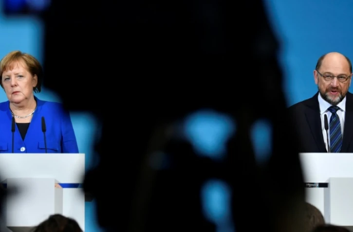 La chancelière allemande Angela Merkel (CDU) et le président du parti social démocrate (SPD) Martin Schulz (D) lors d'une conférence de presse le 12 janvier 2018 à Berlin 