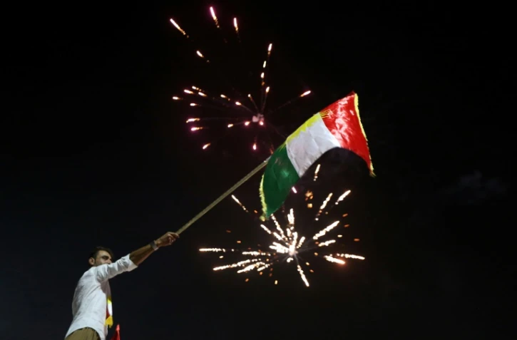 Des kurdes irakiens agitent le drapeau kurde à Erbil (nord) après le vote au référendum d'indépendance, le 25 septembre 2017