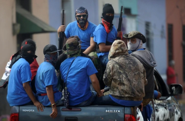 Les forces paramilitaires loyales au président Ortega patrouillent dans les rues de Masaya au Nicaragua, reprise la veille aux rebelles, le 18 juillet 2018