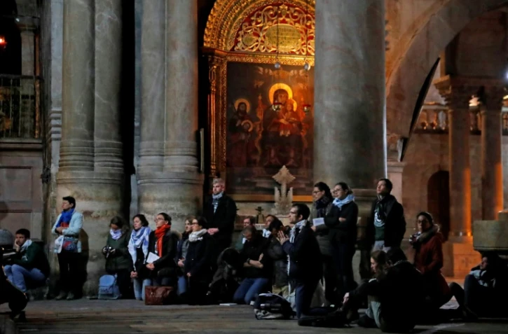 Des fidèles prient dans l'église de Saint-Sépulcre, à Jérusalem, rouverte le 28 février 2018 après trois jours de fermeture