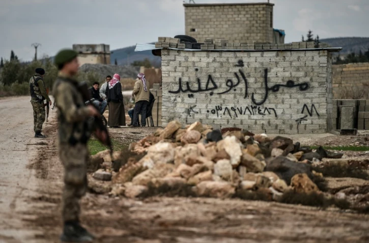 Des rebelles syriens soutenus par la Turquie Ă un checkpoint dans la ville syrienne de Azaz sur la route menant Ă Afrine (nord-ouest de la Syrie), le 27 janvier 2018