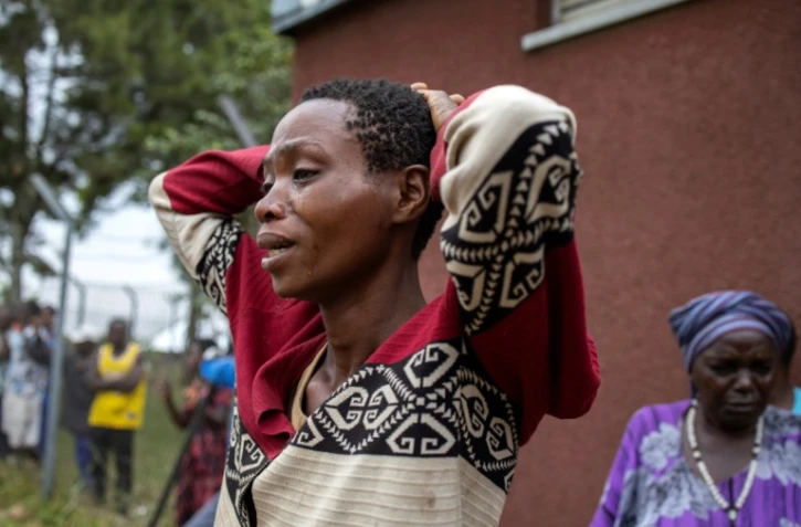 La parente d'une victime de l'attaque contre le lycée de Mpondwe pleure devant la morgue de l'hôpital général de Bwera, le 18 juin 2023

