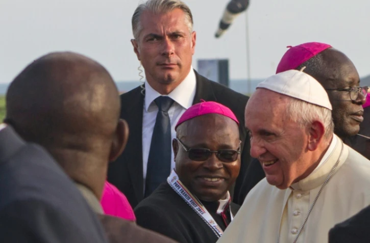 Le pape François (d) salue des dignitaires à son arrivée en Ouganda, le 27 novembre 2015 à Entebbe