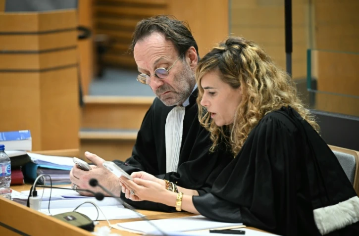 Alexandre Martin (G) and Emmanuelle Franck (D), avocats de Cédric Jubillar, à Albi, le 13 octobre 2025