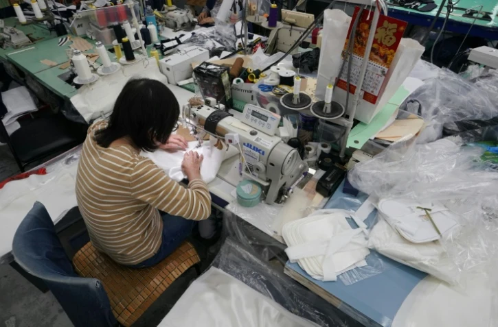 Une employée confectionne une pièce de luxe dans l'atelier de Ferrara Manufacturing, en activité depuis plus de 30 ans dans le "Garment District" new-yorkais, le 16 janvier 2020
