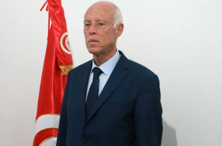 Le candidat indépendant à la présidentielle Kais Saied pose devant le drapeau tunisien, le 15 septembre 2019 à Tunis