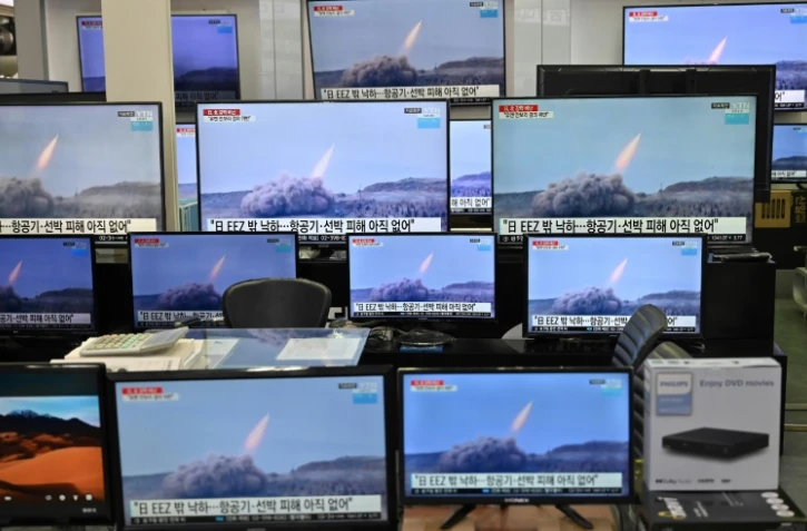 Des images d'un tir de missile nord-coréen sur des écrans dans une boutique de matériel informatique, le 25 mars 2021 à Séoul, en Corée du Sud
