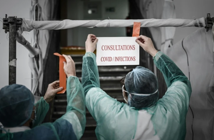 Affichage d'un écriteau pour des consultations et de tests de Covid-19, à Paris le 27 mars 2020