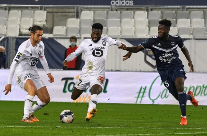 L'attaquant de Lille, Jonathan Bamba, tire au but sous les yeux du défenseur de Bordeaux, Enock Kwateng, lors de leur match de L1, le 3 février 2021 au stade Matmut Atlantique à Bordeaux
