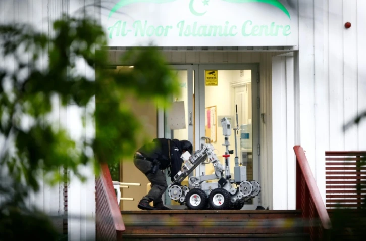 Un policier norvégien manipule un robot après la fusillade dans un mosquée près d'Oslo, à Baerum, le 10 août 2019