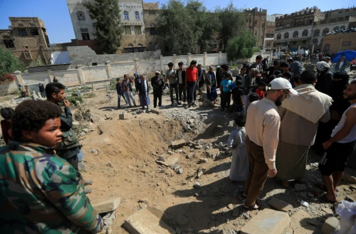 Des habitants observent les dégâts causés par une frappe aérienne à Sanaa, tenue par les rebelles houthis, le 20 avril 2025 au Yémen