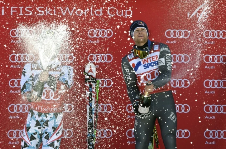 Alexis Pinturault (d) fête au champagne sa victoire en slalom géant à Val-d'Isère, le 10 décembre 2016