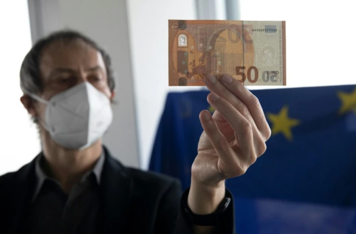 Eric Languillat, l'un des experts du laboratoire anti-contrefaçons de la Banque centrale européenne, vérifie un billet de 50 euros, le 22 décembre 2021 à Francfort, en Allemagne