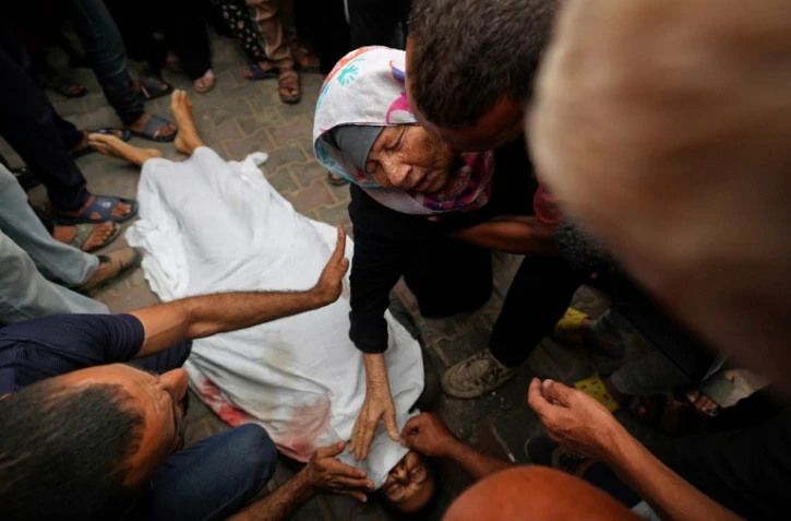 Photo d'archive d'une Palestinienne près du corps d'un membre de sa famille, à Deir al-Balah, dans le centre de la bande de Gaza, le 3 juin 2024