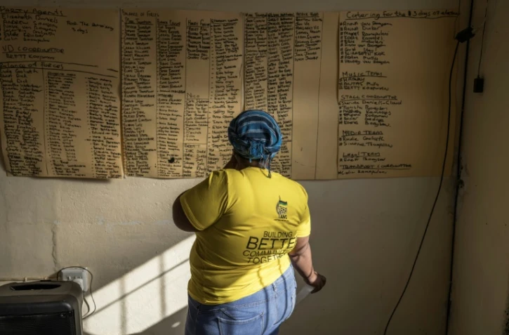Une sympathisante du Congrès national africain (ANC) regarde une liste de noms pour une réunion de campagne à Philipstown, le 22 mai 2024 en Afrique du Sud