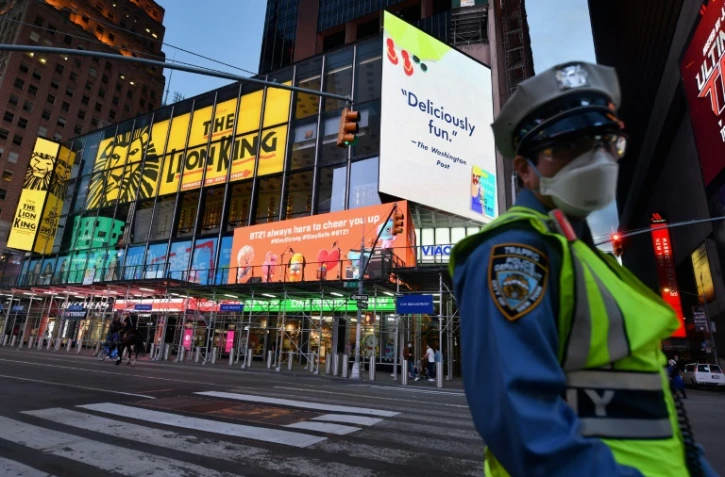 Un policier porte un masque de protection Ă Times Square, le 27 mai 2020 Ă New York