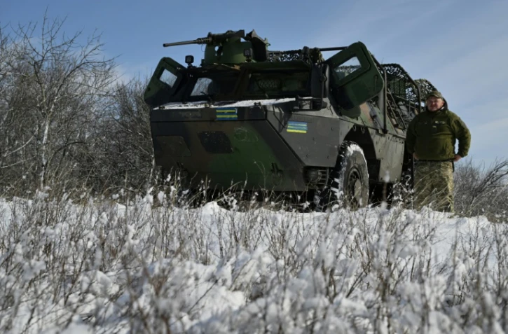 Le chauffeur militaire ukrainien Moroz, de la 24e brigade mécanisée, à côté de son véhicule blindé de transport de troupes (VAB) de fabrication française, lors d'un entraînement dans la région de Donetsk, le 16 février 2025 en Ukraine