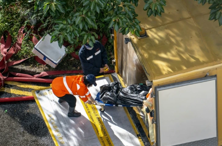 Evacuation du corps d'une victime de l'incendie d'un bloc d'immeubles résidentiels à Hong Kong, le 28 novembre 2025
