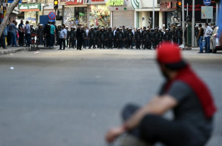 Un homme face aux forces de sécurité pendant une manifestation, le 15 avril dans le centre du Caire, appelant à la "chute du régime" du président Sissi