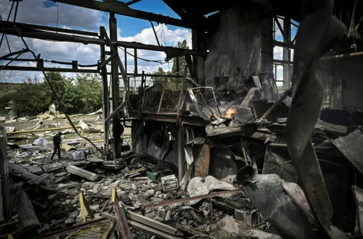 Un homme passe près d'une usine détruite par un bombardement à Bakhmout, dans l'est de l'Ukraine, le 27 mai 2022